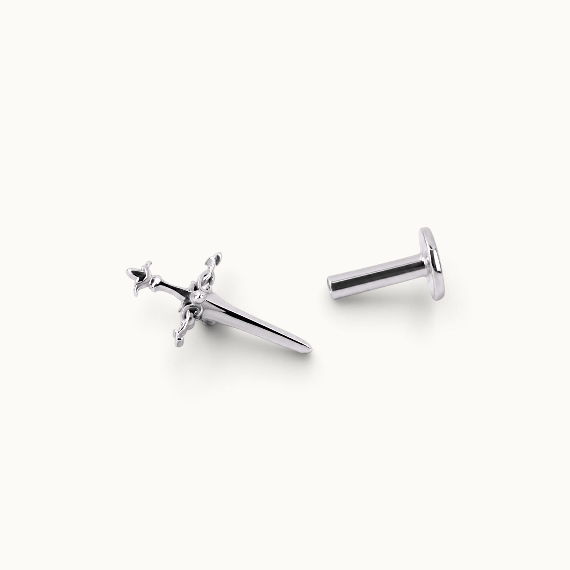 Sword-shaped 18k gold piercing jewelry with intricate details, ideal for ear or nose piercings.