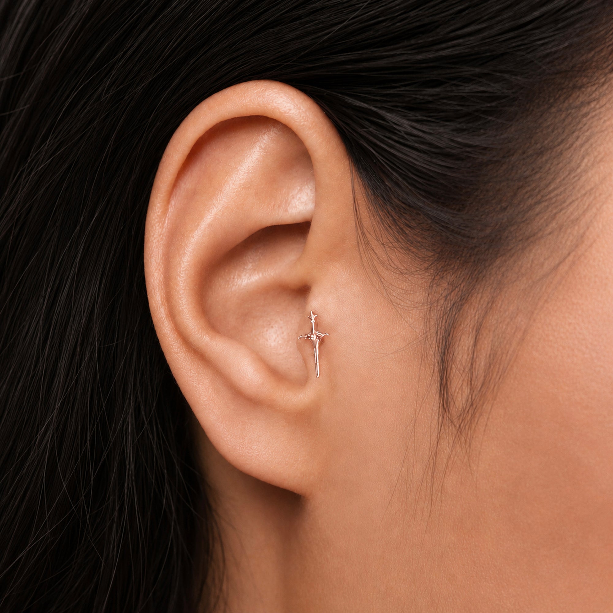 Delicate 18k gold cross earring in ear lobe, luxury handmade body jewelry for elegant style